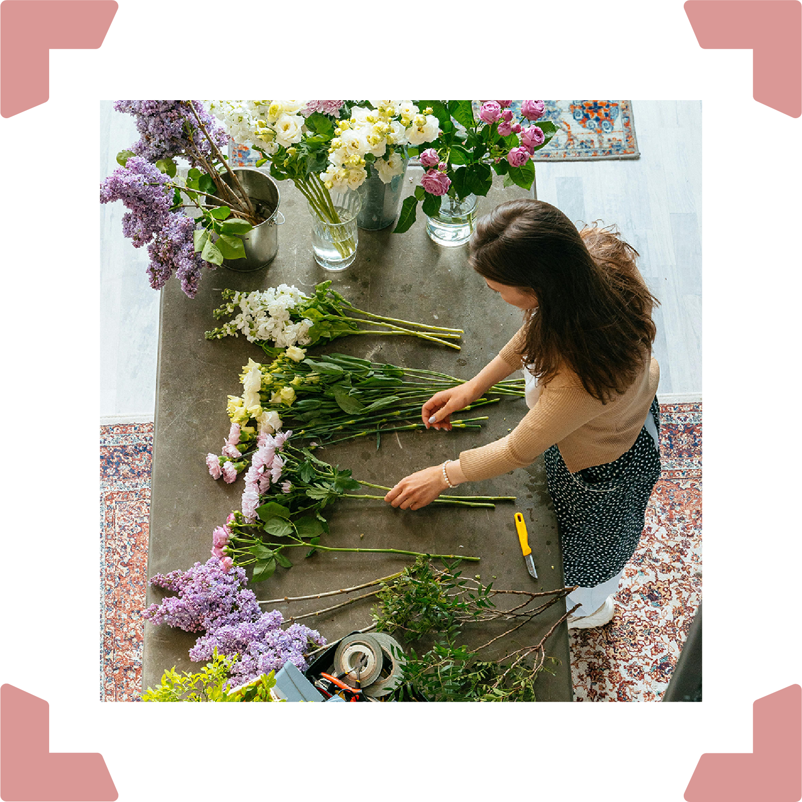 Woman assembles flowers on a table